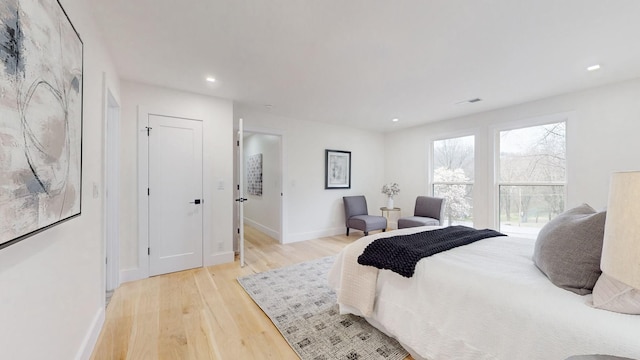 bedroom with baseboards, recessed lighting, visible vents, and light wood-style floors