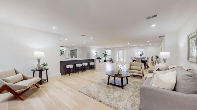 living area featuring light wood finished floors, visible vents, and recessed lighting