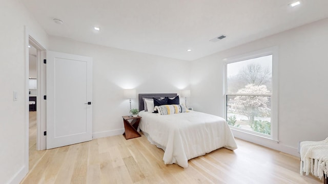 bedroom with light wood-type flooring, baseboards, visible vents, and recessed lighting