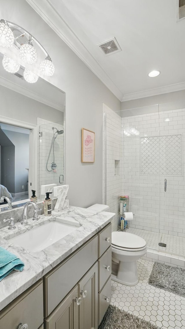 bathroom with a stall shower, visible vents, and crown molding