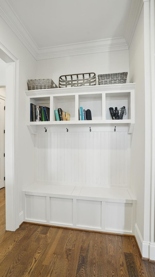 mudroom featuring baseboards, ornamental molding, and dark wood finished floors