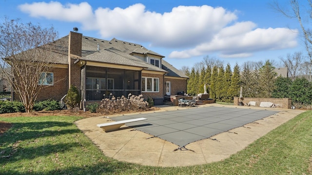 view of pool featuring a patio area, a sunroom, and a yard