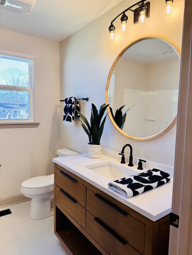 bathroom with visible vents, vanity, and toilet