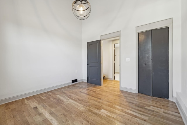 unfurnished bedroom featuring light wood-type flooring and baseboards