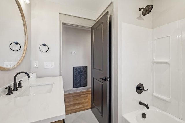 bathroom featuring wood finished floors, vanity, and shower / bathtub combination