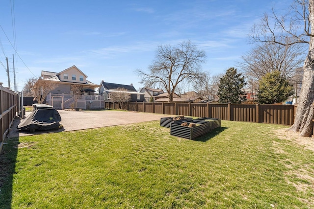 view of yard with a fenced backyard, a vegetable garden, and a patio