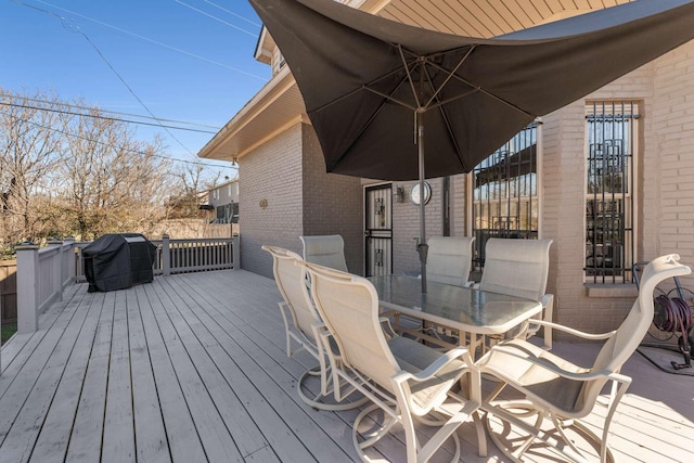 deck featuring outdoor dining area and a grill