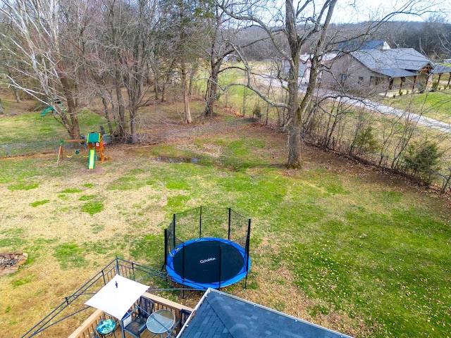 view of yard featuring a trampoline and a playground