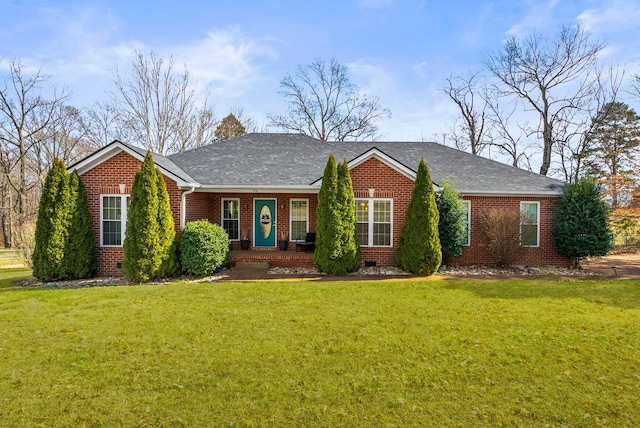 ranch-style home with roof with shingles, brick siding, and a front lawn