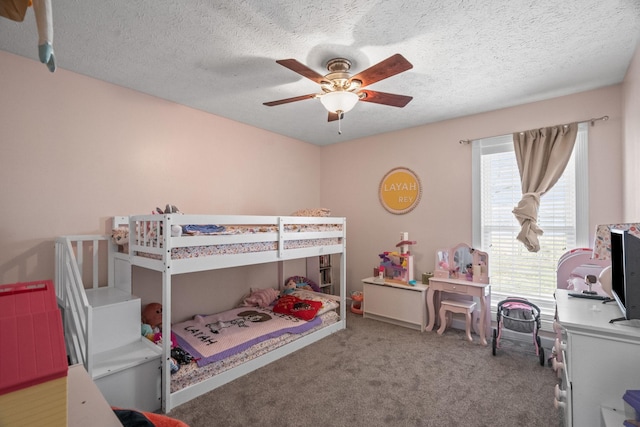 carpeted bedroom with a textured ceiling and a ceiling fan