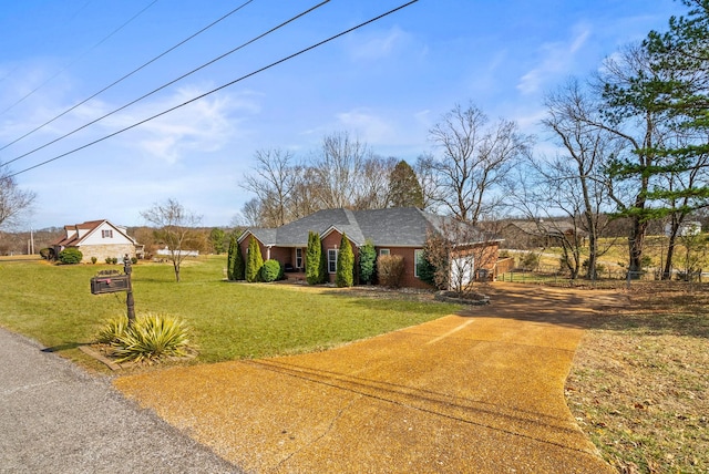 view of front of home featuring a garage, a front lawn, and concrete driveway