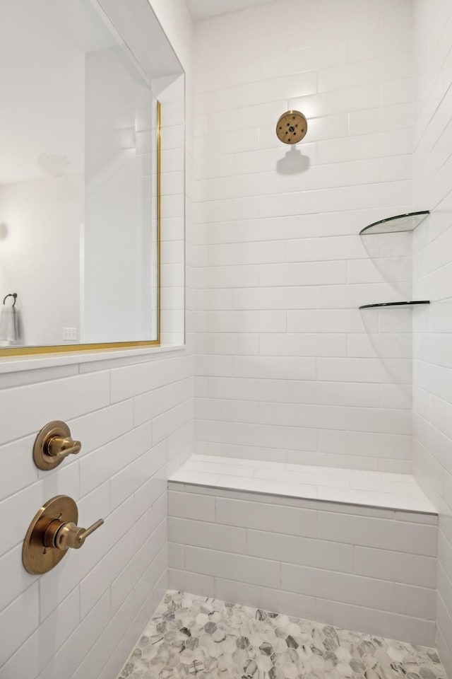 bathroom with a tile shower