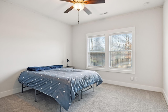 bedroom with carpet floors, baseboards, visible vents, and ceiling fan