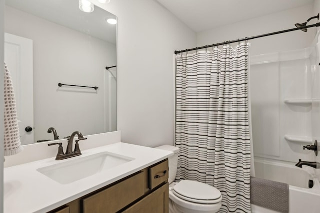 bathroom with toilet, shower / tub combo, and vanity