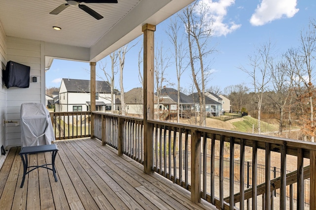 wooden terrace with a residential view and ceiling fan