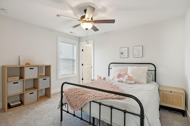 carpeted bedroom with baseboards, visible vents, and ceiling fan