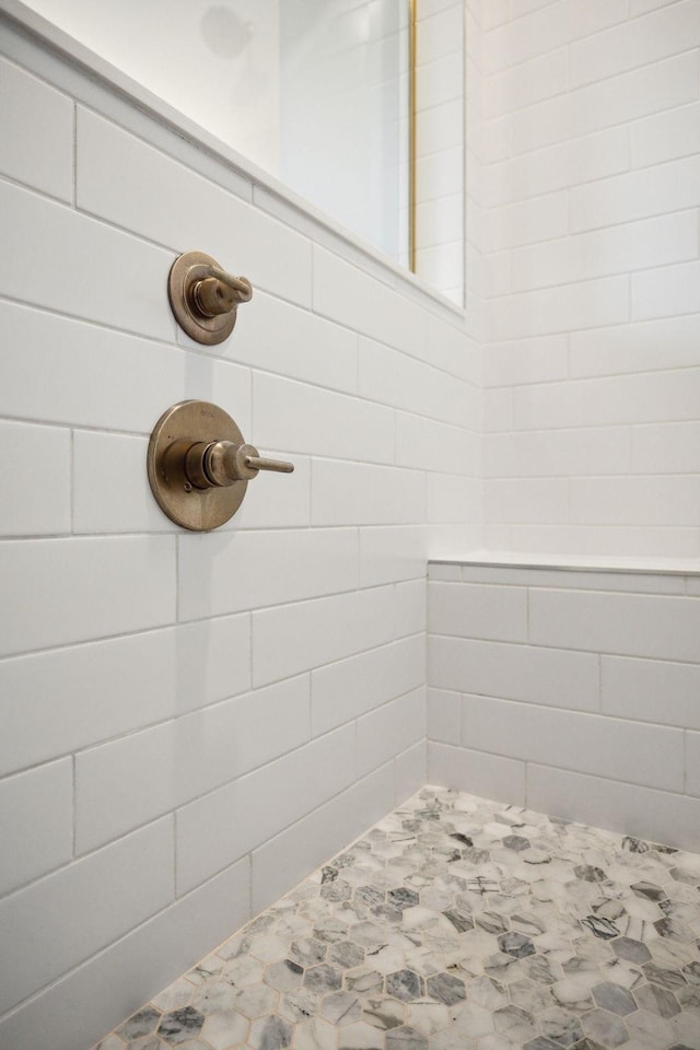 interior details featuring tiled shower