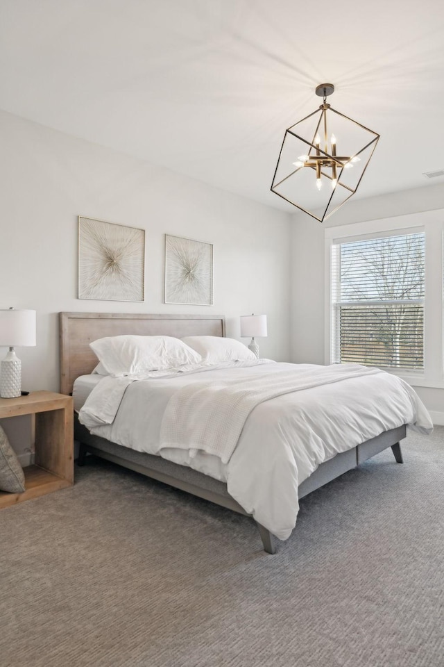 carpeted bedroom with visible vents and a chandelier