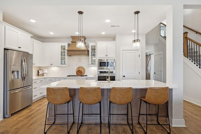 kitchen featuring white cabinetry, visible vents, stainless steel appliances, and wood finished floors