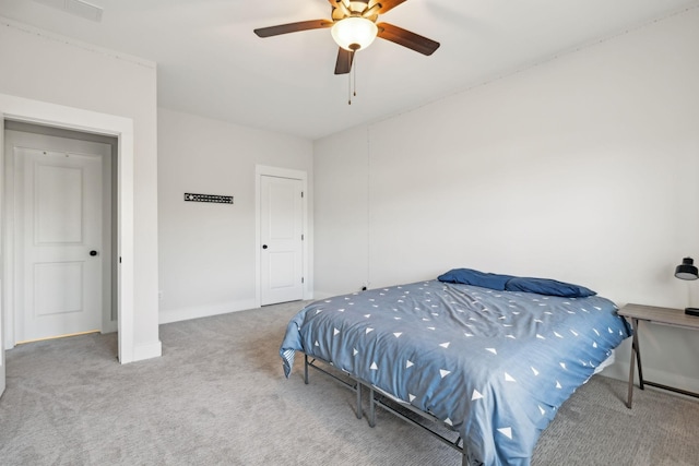 carpeted bedroom with a ceiling fan, visible vents, and baseboards