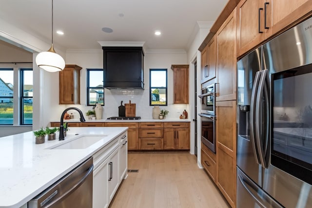 kitchen featuring decorative backsplash, appliances with stainless steel finishes, ornamental molding, custom exhaust hood, and a sink