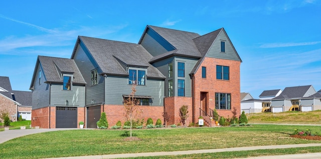 view of front of home featuring a garage, driveway, a front yard, and brick siding