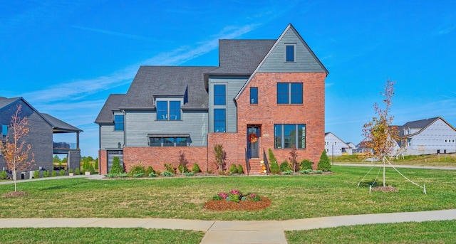 view of front of property with a front yard and brick siding