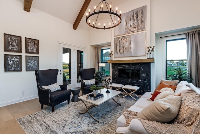 living area featuring high vaulted ceiling, a premium fireplace, wood finished floors, and beam ceiling