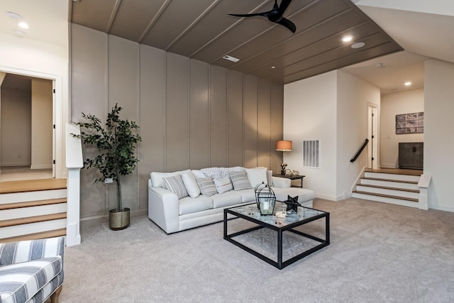 living room with recessed lighting, carpet flooring, visible vents, and stairs