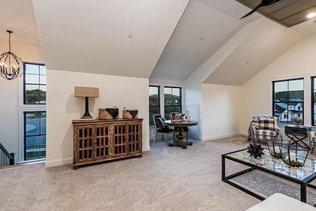 living room with vaulted ceiling, plenty of natural light, carpet, and a notable chandelier