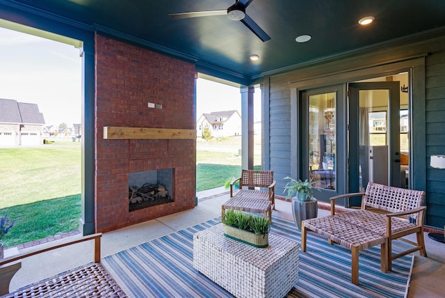 view of patio with an outdoor brick fireplace and a ceiling fan