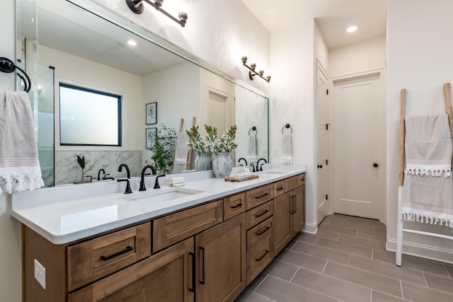 full bath featuring double vanity, tile patterned flooring, a sink, and recessed lighting