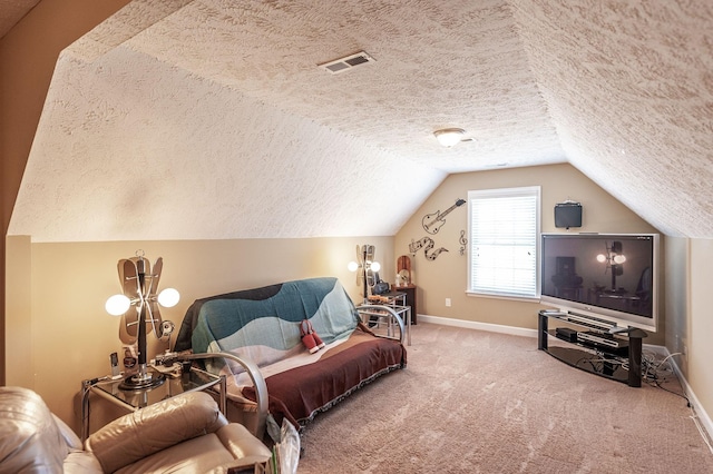 carpeted bedroom with visible vents, baseboards, vaulted ceiling, and a textured ceiling