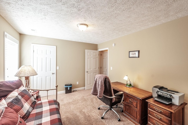 office space featuring light carpet, a textured ceiling, and baseboards