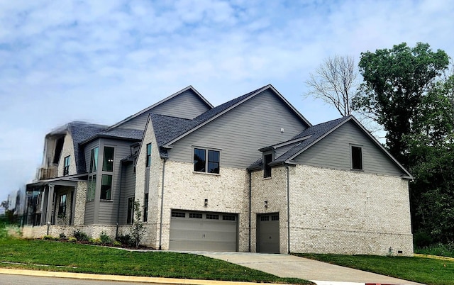 view of side of property with an attached garage, a yard, concrete driveway, and brick siding