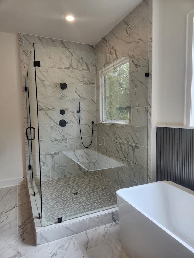 bathroom with recessed lighting, marble finish floor, a freestanding tub, and a marble finish shower