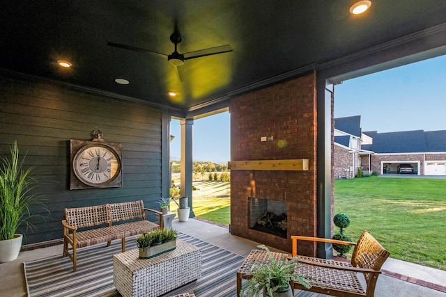 view of patio / terrace with an outdoor brick fireplace and a ceiling fan