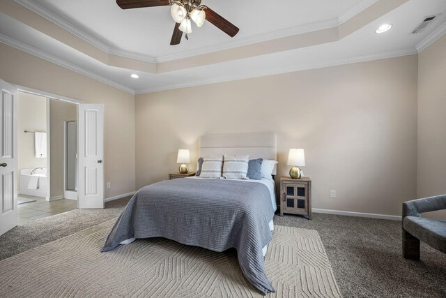 bedroom featuring crown molding, a tray ceiling, carpet, and baseboards