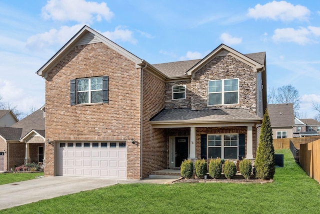 view of front of home featuring a garage, driveway, fence, a front yard, and brick siding