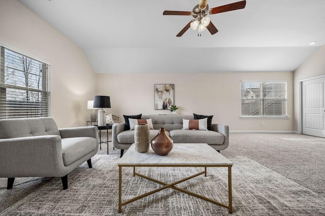 living room with lofted ceiling, carpet floors, a ceiling fan, and baseboards