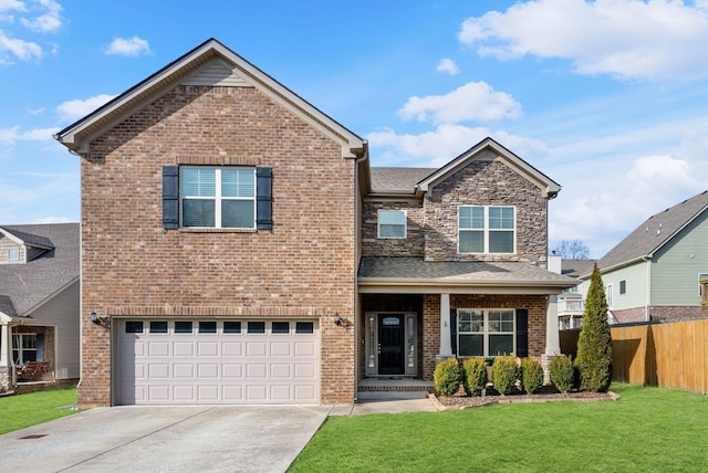 view of front of property featuring an attached garage, brick siding, fence, and a front lawn