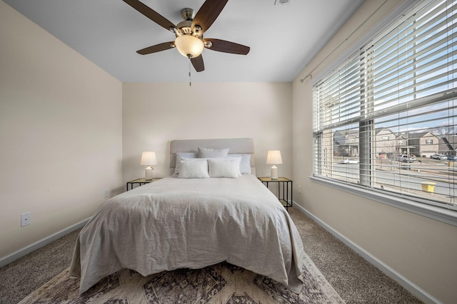 bedroom featuring a ceiling fan, carpet, and baseboards