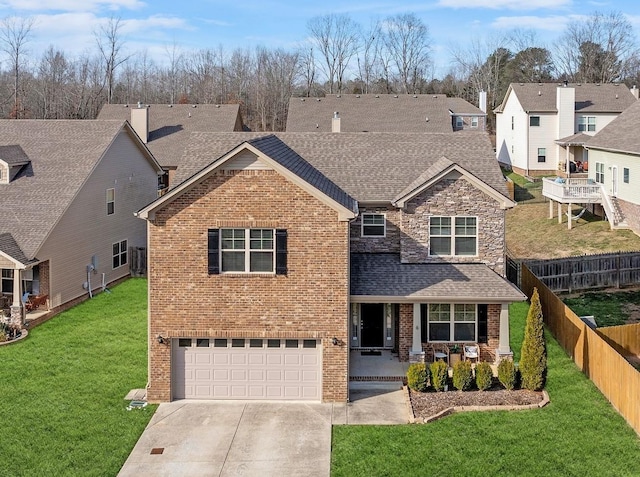 traditional-style house featuring a garage, driveway, roof with shingles, covered porch, and a front yard