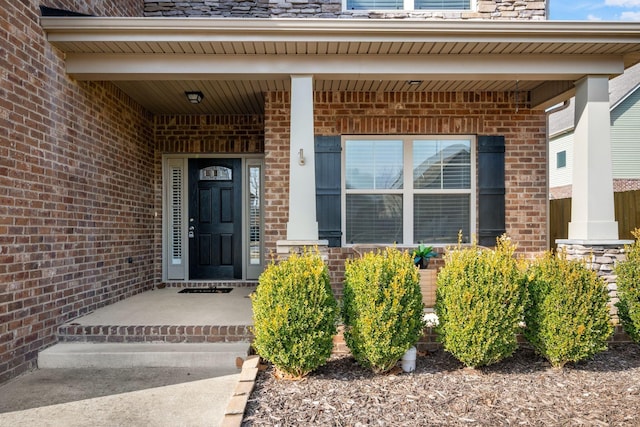 doorway to property featuring brick siding