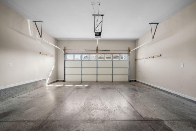 garage featuring a garage door opener and baseboards