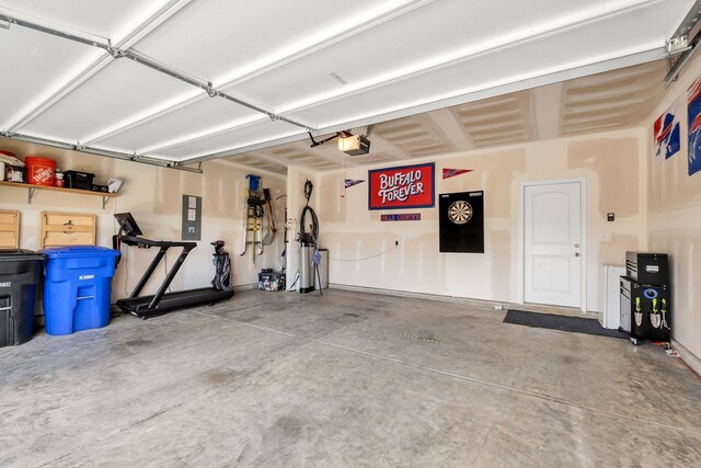 garage featuring electric panel and a garage door opener