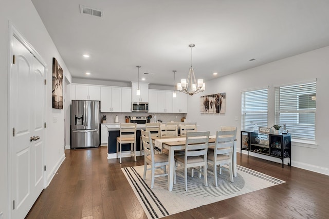 dining space featuring baseboards, visible vents, dark wood-type flooring, an inviting chandelier, and recessed lighting