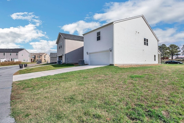 view of home's exterior featuring an attached garage, a residential view, concrete driveway, and a yard