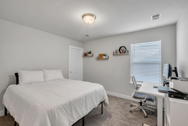 carpeted bedroom with visible vents and baseboards