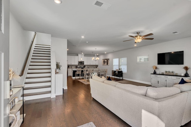 living area with baseboards, visible vents, stairway, dark wood-type flooring, and recessed lighting